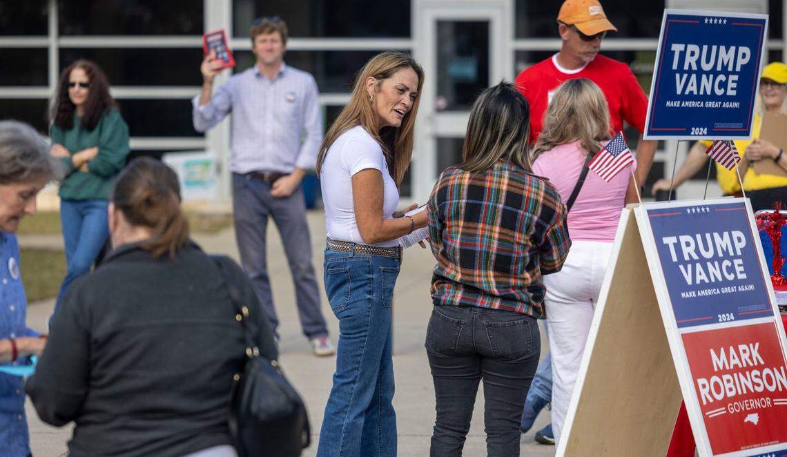 Debbie Drew, center, canvasses for the Republican Party as voters arrive to cast their ballots at the Barwell Road Community Center on Tuesday, November 5, 2024 in Raleigh, N.C.
