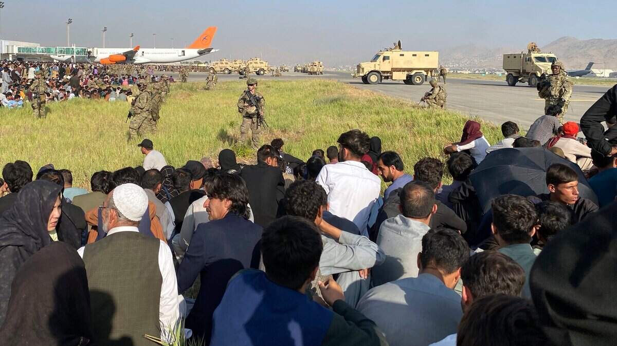 U.S soldiers stand guard along a perimeter at the international airport in Kabul, Afghanistan, Monday, Aug. 16, 2021. On Monday, the U.S. military and officials focus was on Kabul’s airport, where thousands of Afghans trapped by the sudden Taliban takeover rushed the tarmac and clung to U.S. military planes deployed to fly out staffers of the U.S. Embassy, which shut down Sunday, and others.