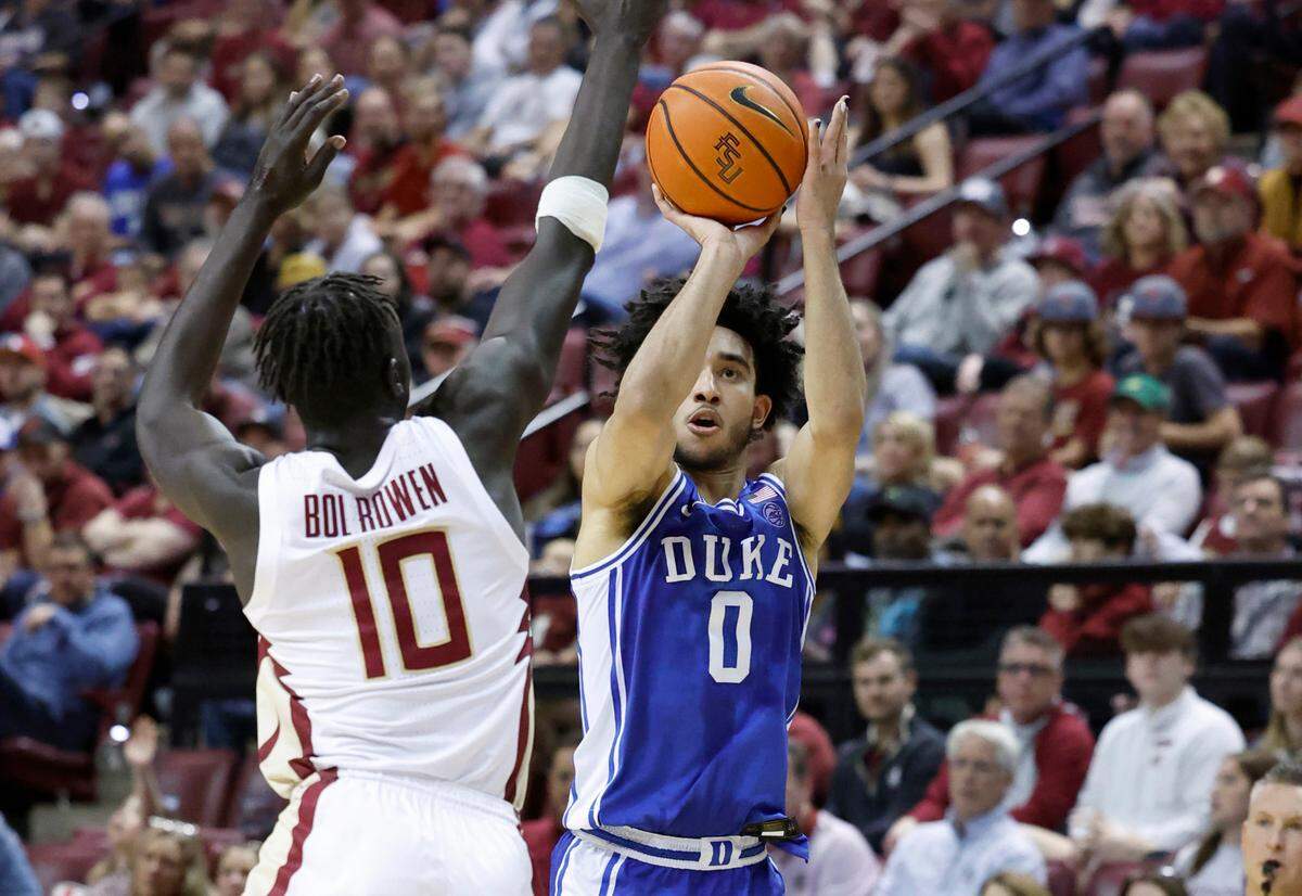 Duke’s Jared McCain (0) shoots a three-pointer as Florida State’s Taylor Bol Bowen (10) defends during the first half of Duke’s game against Florida State University at the Tucker Center in Tallahassee, Fla. Sat. February 17, 2024.