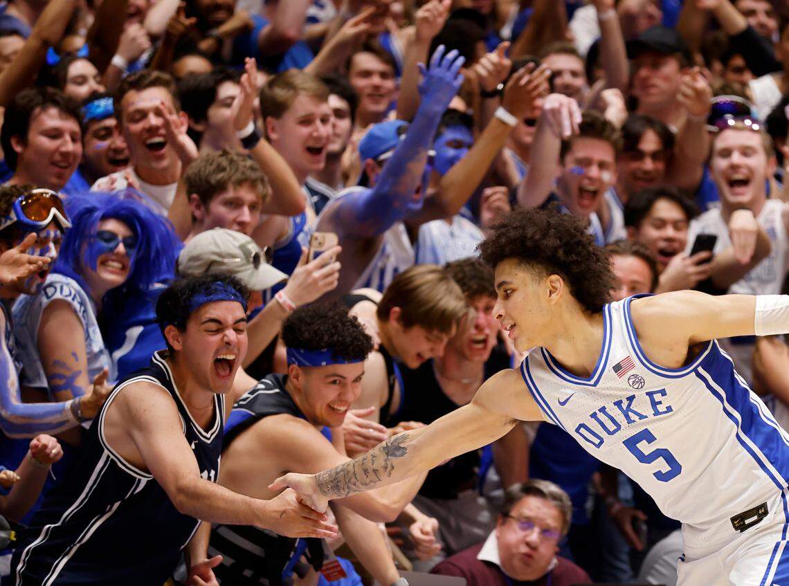 Duke’s Tyrese Proctor high-fives a fan late in the second half of the Blue Devils’ 71-67 win over N.C. State on Tuesday, Feb. 28, 2023, at Cameron Indoor Stadium in Durham, N.C.