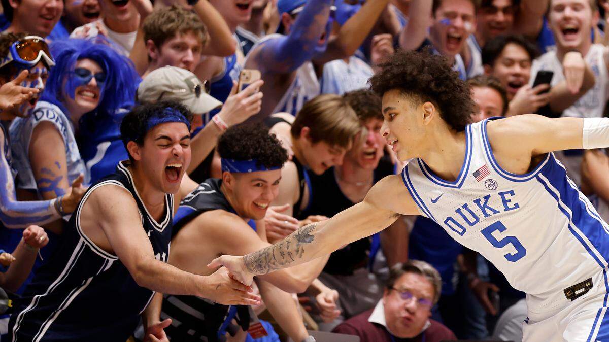 Duke’s Tyrese Proctor high-fives a fan late in the second half of the Blue Devils’ 71-67 win over N.C. State on Tuesday, Feb. 28, 2023, at Cameron Indoor Stadium in Durham, N.C.