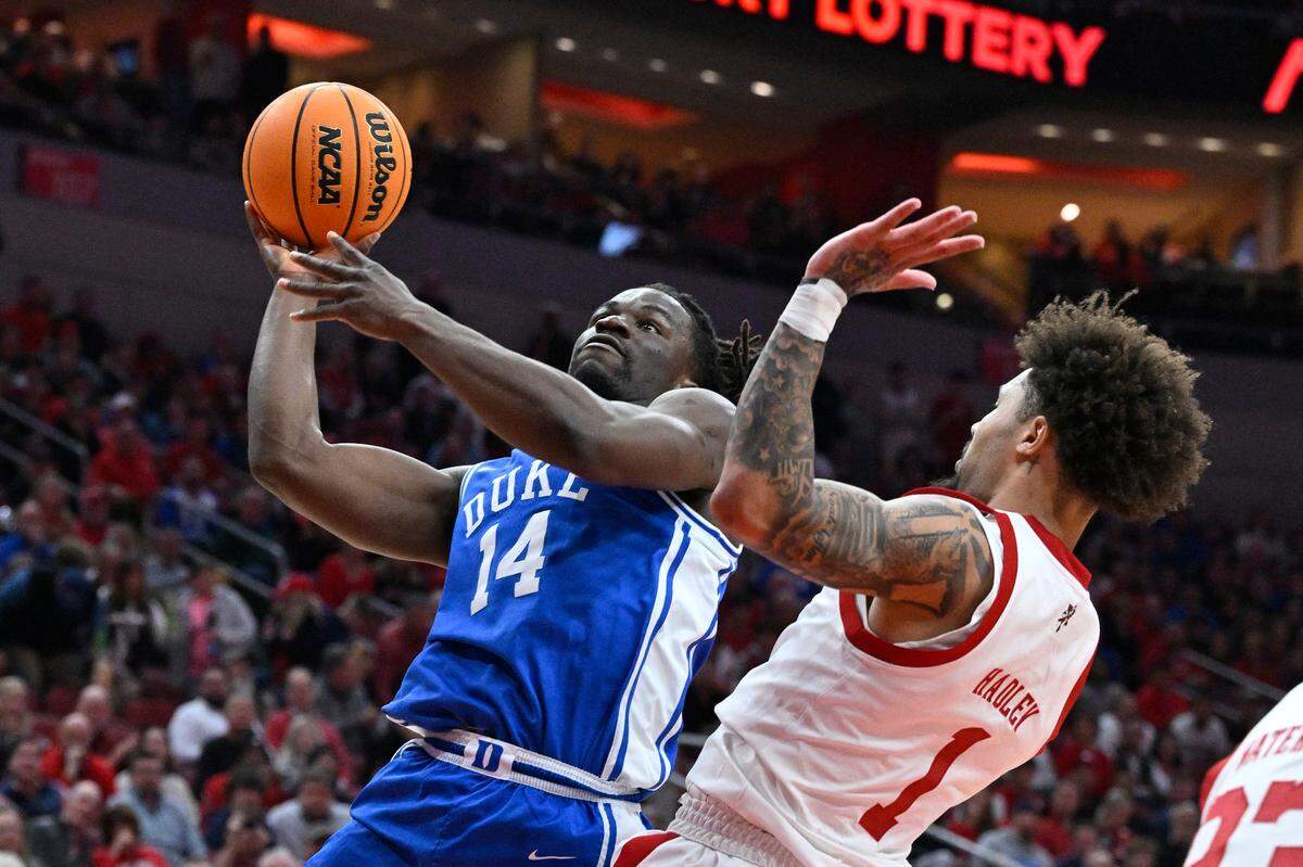 Duke Blue Devils guard Sion James (14) shoots against Louisville Cardinals guard J’Vonne Hadley (1) during the first half at KFC Yum! Center on Sunday, Dec. 8, 2024.