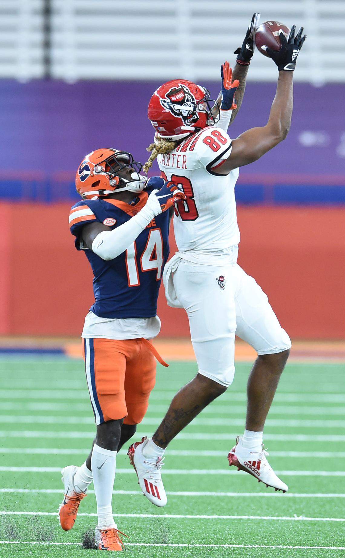 North Carolina State Wolfpack wide receiver Devin Carter (88) goes up for pass over Syracuse Orange defensive back Garrett Williams (14) in the second half on Saturday, Nov. 28, 2020, at the Carrier Dome in Syracuse, N.Y.