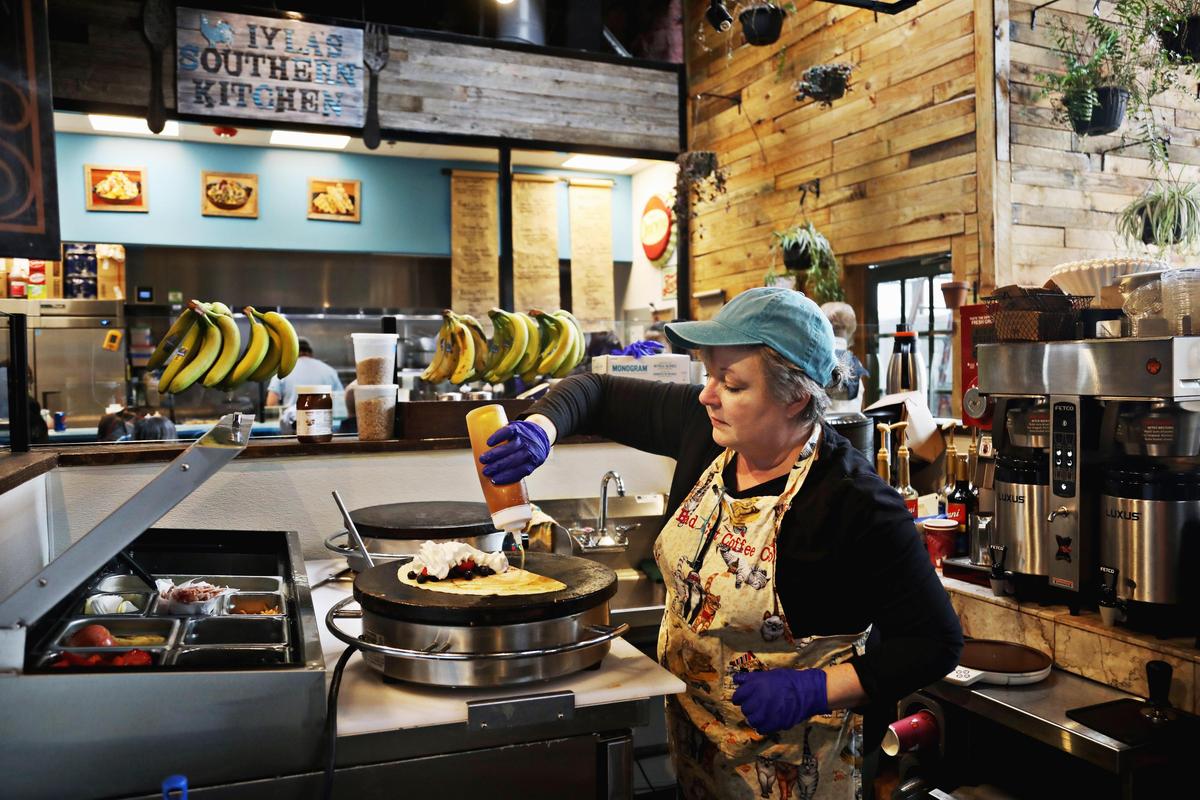 Bad Cat Coffee Company owner Traci Davis makes a berry crêpe on Tuesday, March 5, 2019.