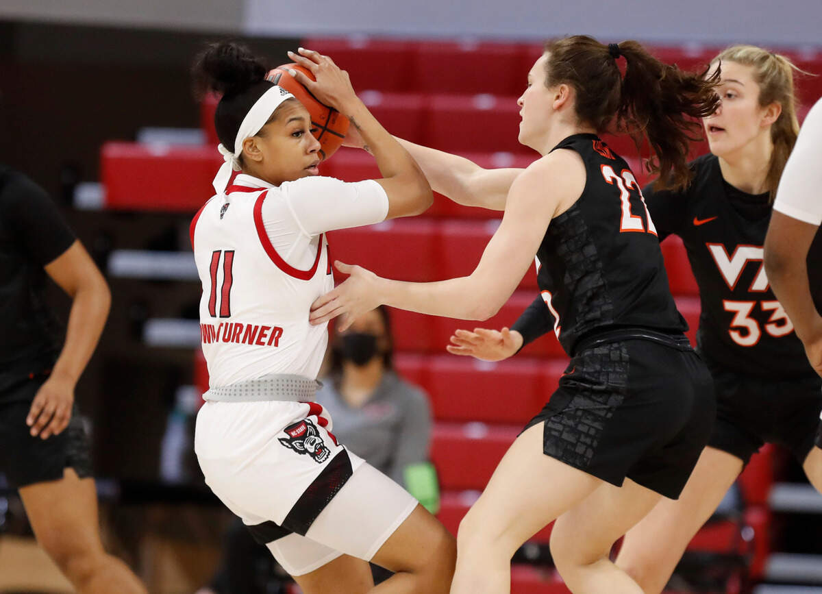 N.C. State’s Jakia Brown-Turner (11) keeps the ball from Virginia Tech’s Cayla King (22) during the first half of N.C. State’s game against Virginia Tech at Reynolds Coliseum in Raleigh, N.C., Sunday, January 24, 2021.