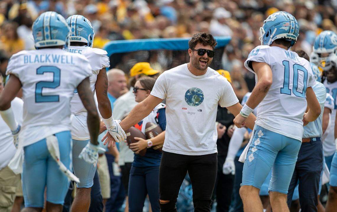 Former North Carolina quarterback Sam Howell greets North Carolina quarterback Drake Maye (10) and the offensive unit after scoring their first touchdown against Appalachian State on Saturday, September 3, 2022 at Kidd Brewer Stadium in Boone, N.C.