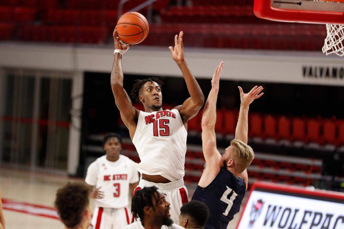 N.C. State’s Manny Bates (15) shoots as North Florida’s Josh Endicott (4) defends during the second half of N.C. State’s 86-51 victory over North Florida in the Mako Medical Wolfpack Invitational at Reynolds Coliseum in Raleigh, N.C., Friday, Nov. 27, 2020.