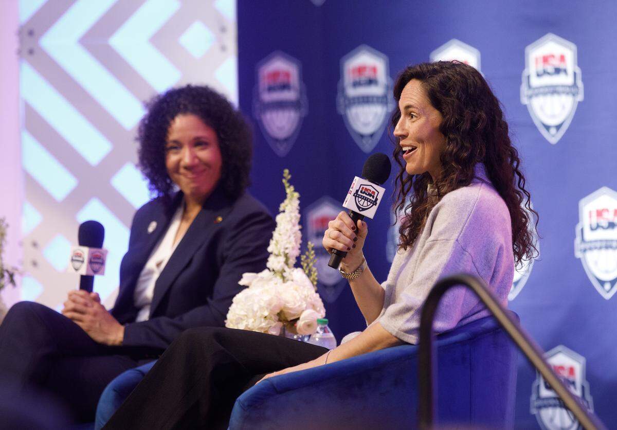 Duke women’s basketball head coach Kara Lawson listens as Sue Bird, USA Basketball’s Women’s National Team managing director, speaks during a ceremony on Tuesday, Sept. 23, 2025, at Cameron Indoor Stadium honoring Lawson as the head coach of the team through 2028.