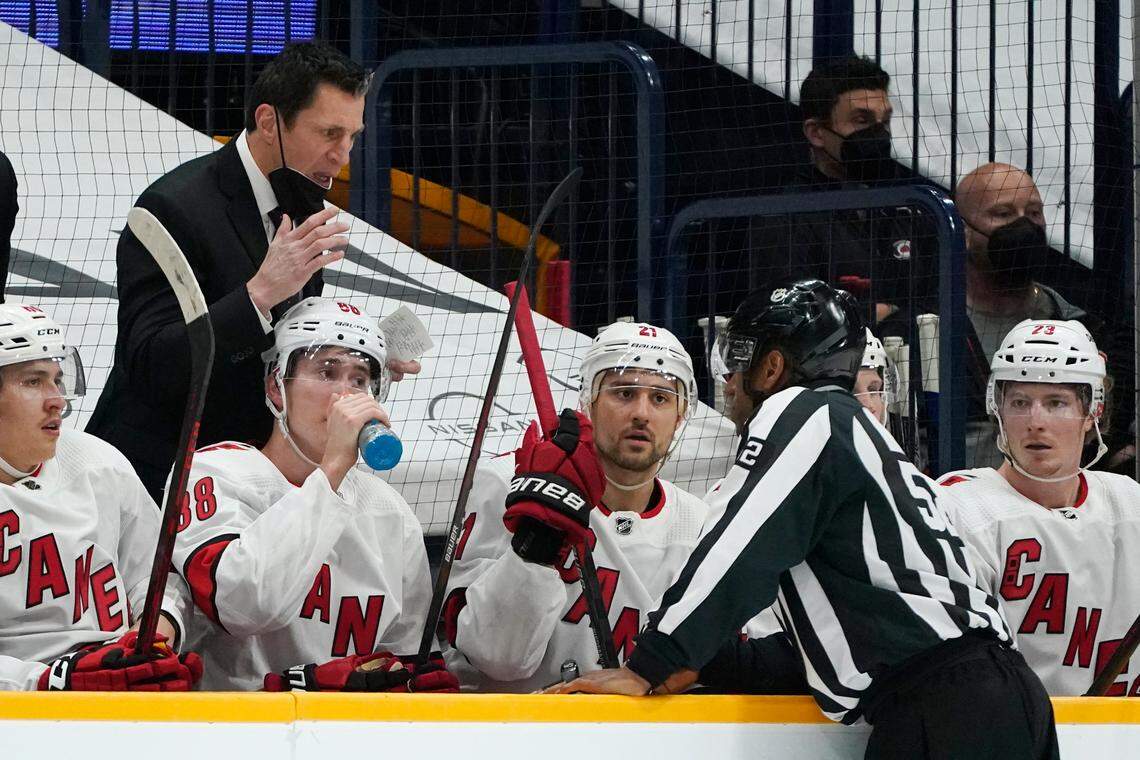 Carolina Hurricanes head coach Rod Brind’Amour, left, questions a call during the first period in Game 4 of an NHL hockey Stanley Cup first-round playoff series against the Nashville Predators Sunday, May 23, 2021, in Nashville, Tenn. (AP Photo/Mark Humphrey)