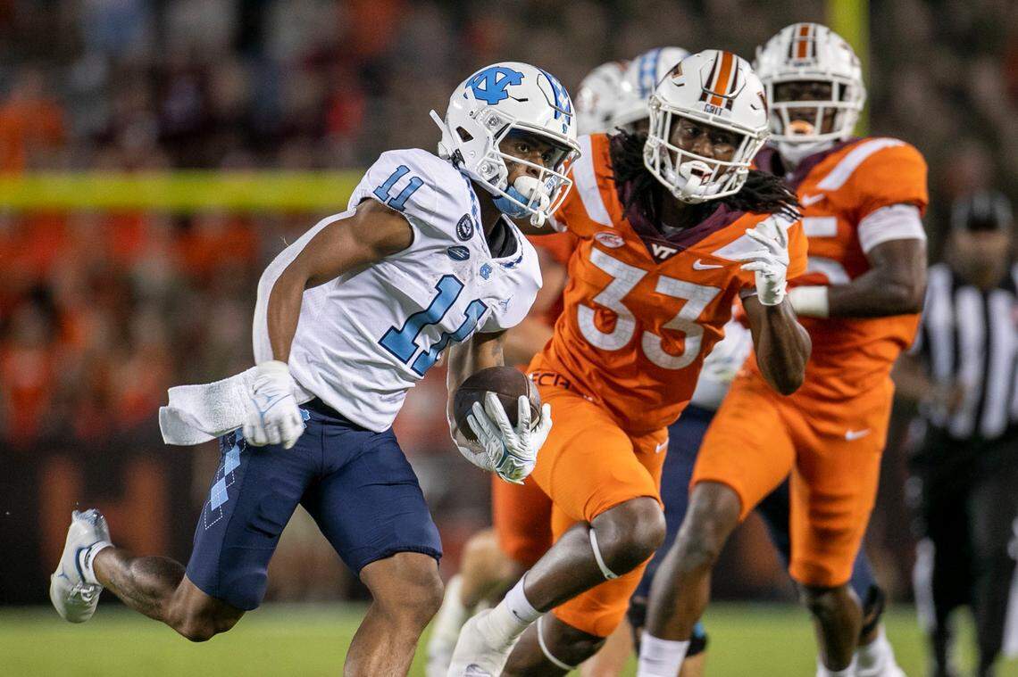 North Carolina’s Josh Downs (11) romps 37 yards for a touchdown in the third quarter against Virginia Tech on Friday, September 3, 2021 at Lane Stadium in Blacksburg, Va.