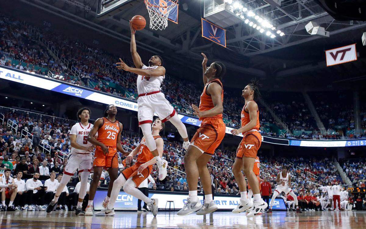 N.C. State’s Casey Morsell (14) drives to the basket past Virginia Tech’s Mylyjael Poteat (34) during N.C. State’s 97-77 victory over Virginia Tech in the second round of the ACC Men’s Basketball Tournament in Greensboro, N.C., Wednesday, March 8, 2023.