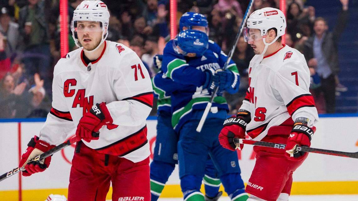 Dec 9, 2023; Vancouver, British Columbia, CAN; Carolina Hurricanes forward Jesper Fast (71) and defenseman Dmitry Orlov (7) react as Vancouver Canucks forward Elias Pettersson (40) and forward Sam Lafferty (18) celebrate Petterssons’ goal in the third period at Rogers Arena. Vancouver won 4-3. Mandatory Credit: Bob Frid-USA TODAY Sports