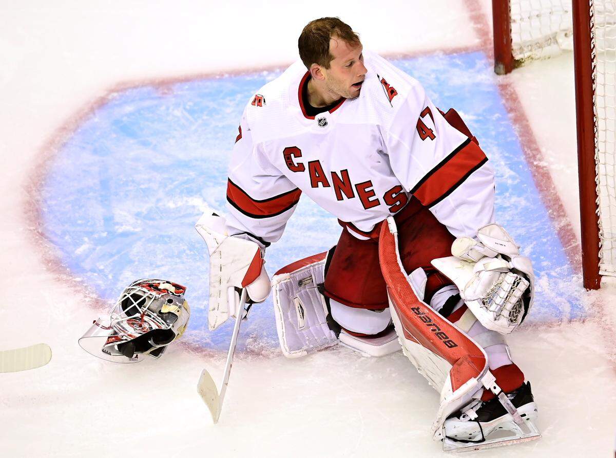 Carolina Hurricanes’ goaltender James Reimer (47) loses his mask during second period NHL Eastern Conference Stanley Cup playoff action against the New York Rangers in Toronto on Tuesday, Aug. 4, 2020. (Frank Gunn/The Canadian Press via AP)