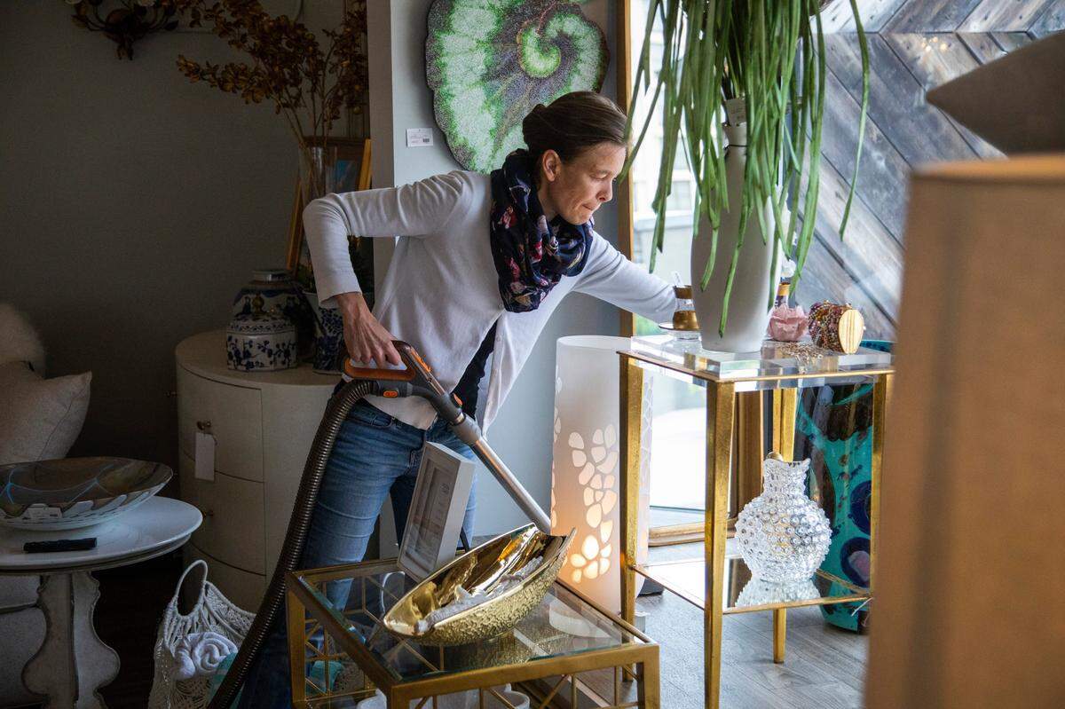 Virginie Birgand vacuums at Paysage, a boutique in North Hills in Raleigh, as the store prepares to open their doors to the public Friday, May 8, 2020. Under the Phase 1 rules, non-essential businesses can open to customers at 5 p.m. Friday, May 8, at 50 percent capacity and with social distancing and strict cleaning rules in place.