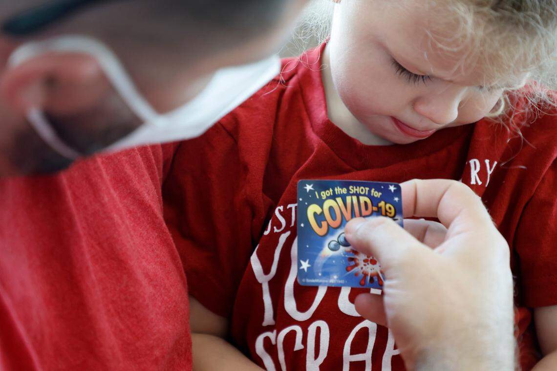 Jared Hocutt of Cary puts a ‘I got the shot’ sticker on his daughter, River, after she received the Moderna COVID-19 vaccine at UNC Family Medicine & Pediatrics at Panther Creek in Cary, N.C., on Friday, June 24, 2022.