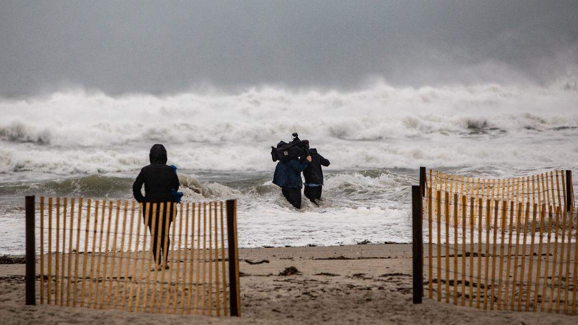 Surf surrounds a television crew during a live broadcast near Oceanana Pier & Pier House Restaurant in Atlantic Beach Thursday, Sept. 13, 2018 as Hurricane Florence approaches the Carolinas.