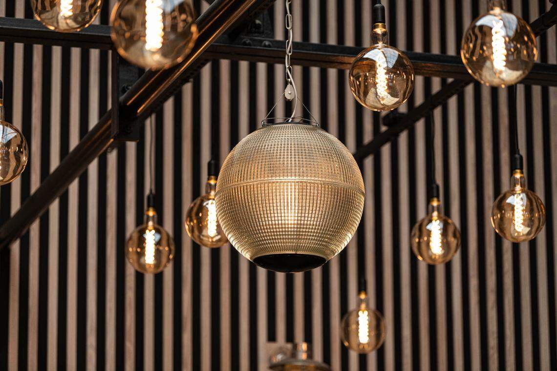 A few dozen clear light bulbs were strung from the ceiling in the new Poole’s Diner space.