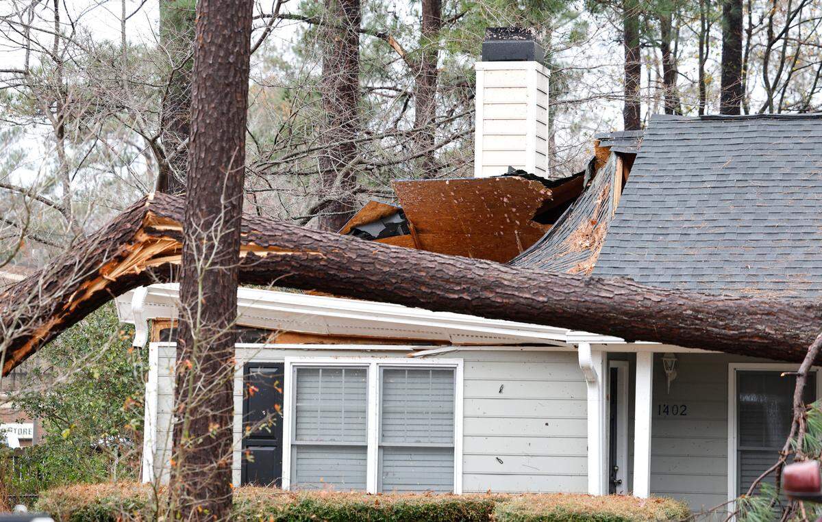 A roof is damaged from a downed tree on a home on Buckhorn Road in Garner, N.C., Sunday, Dec. 10, 2023.