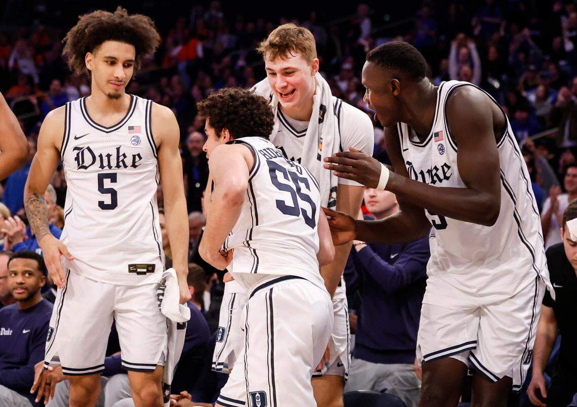 DukeÕs Tyrese Proctor (5), Cooper Flagg (2) and Khaman Maluach (9) cheer on Spencer Hubbard (55) as he prepares to enter the game during the second half of DukeÕs 110-67 victory over Illinois in the SentinelOne Classic at Madison Square Garden in New York City Saturday, Feb. 22, 2025.