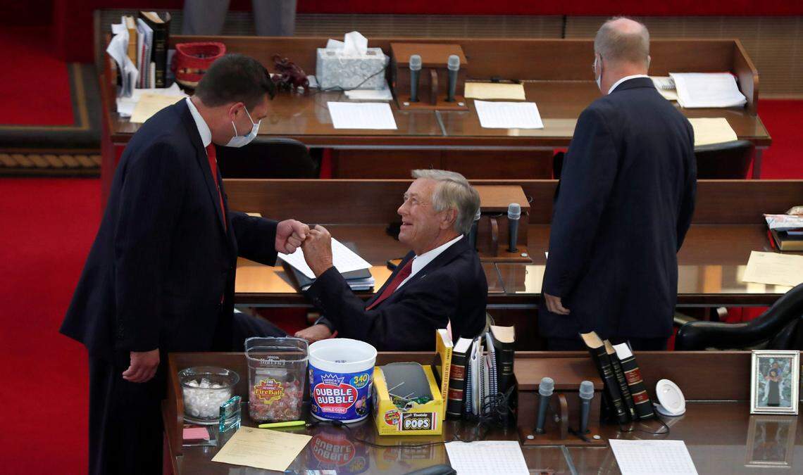 Rep. Jeffrey Elmore, left, fist bumps Rep. William Brisson on the first day of a brief session Wednesday, Sept. 2, 2020. Rep. Michael Wray is to the right.