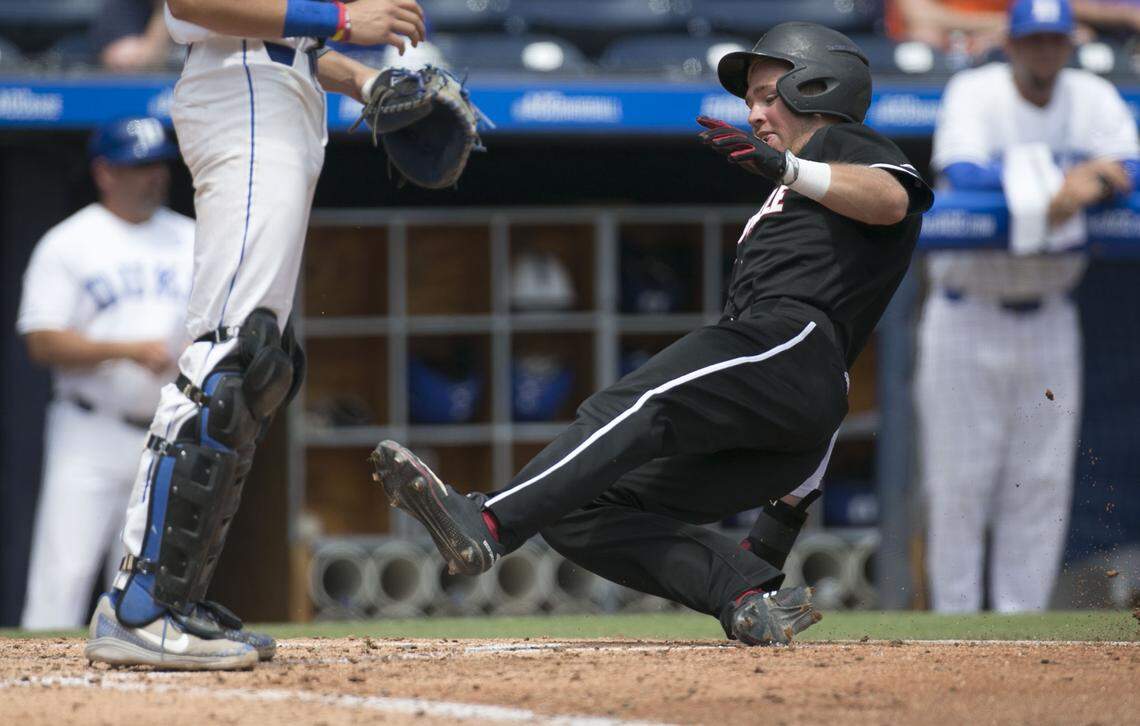 Louisville’s Jake Snider (20) slides in to home under Duke catcher Chris Proctor to score on a double by Devin Mann in the fourth inning during the ACC Championship on Friday, May 25, 2018 at Durham Bulls Athletic Park in Durham, N.C. Louisville scored four runs in the fourth to open an 8-1 lead over Duke.