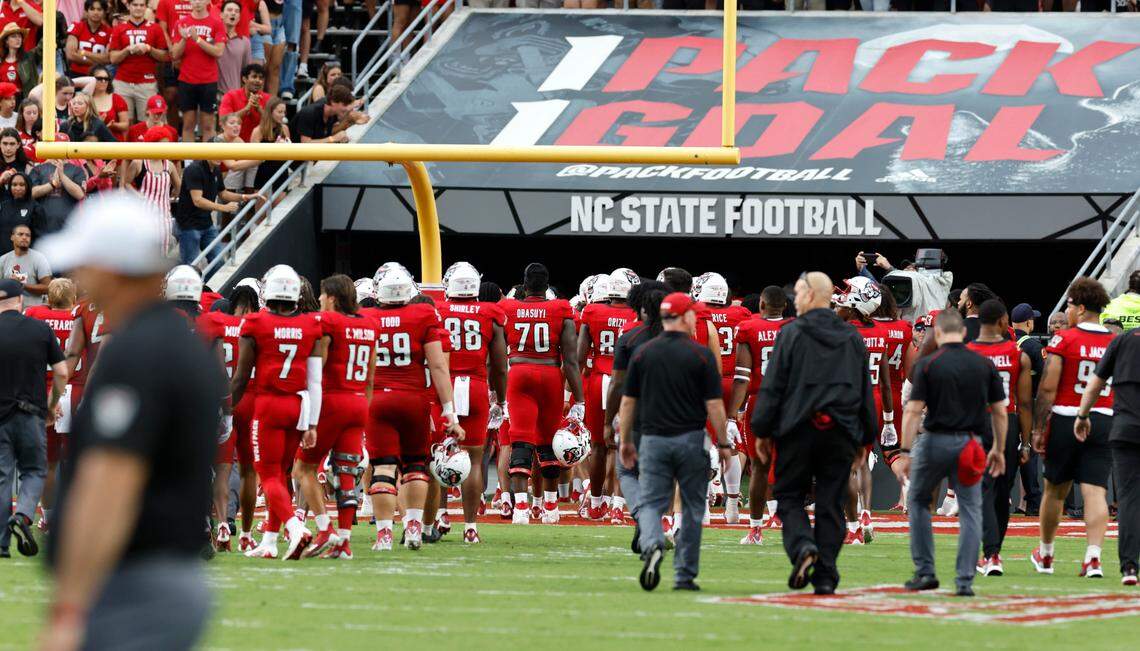 N.C. State football players head towards the locker room after the game was delayed because of weather in the area at the start of the second quarter during the Wolfpack’s game against Notre Dame at Carter-Finley Stadium in Raleigh, N.C., Saturday, Sept. 9, 2023.