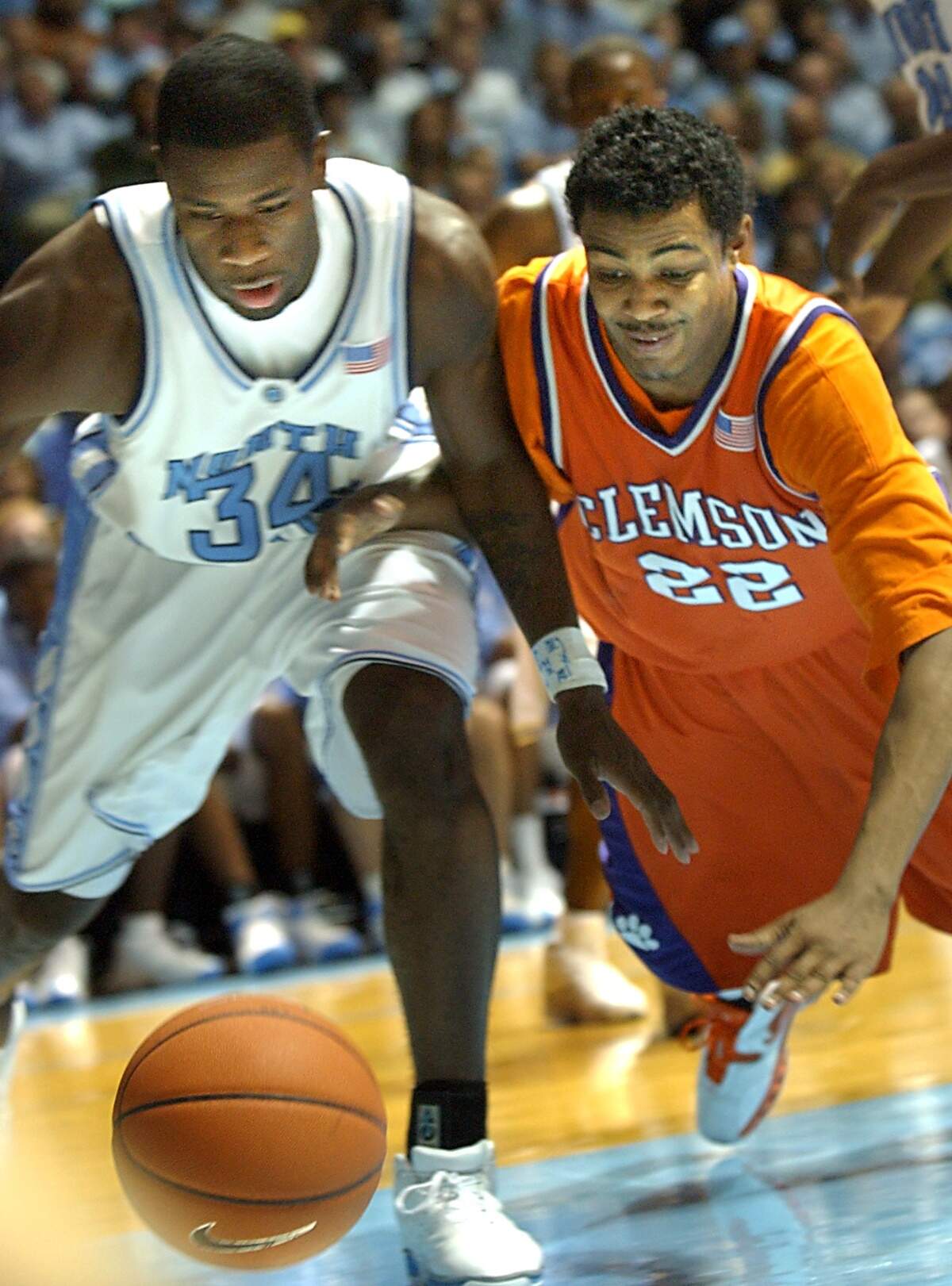 UNC-Chapel Hill’s David Noel, left, and Clemson University’s Shawan Robinson, right, go for a loose ball in this 2005 file photo.