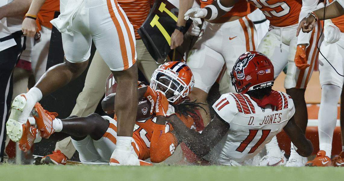 Clemson cornerback Toriano Pride (23) is tackled by N.C. State wide receiver Darryl Jones (11) after intercepting the ball during the second half of Clemson’s 30-20 victory over N.C. State at Memorial Stadium in Clemson, S.C., Saturday, Oct. 1, 2022.