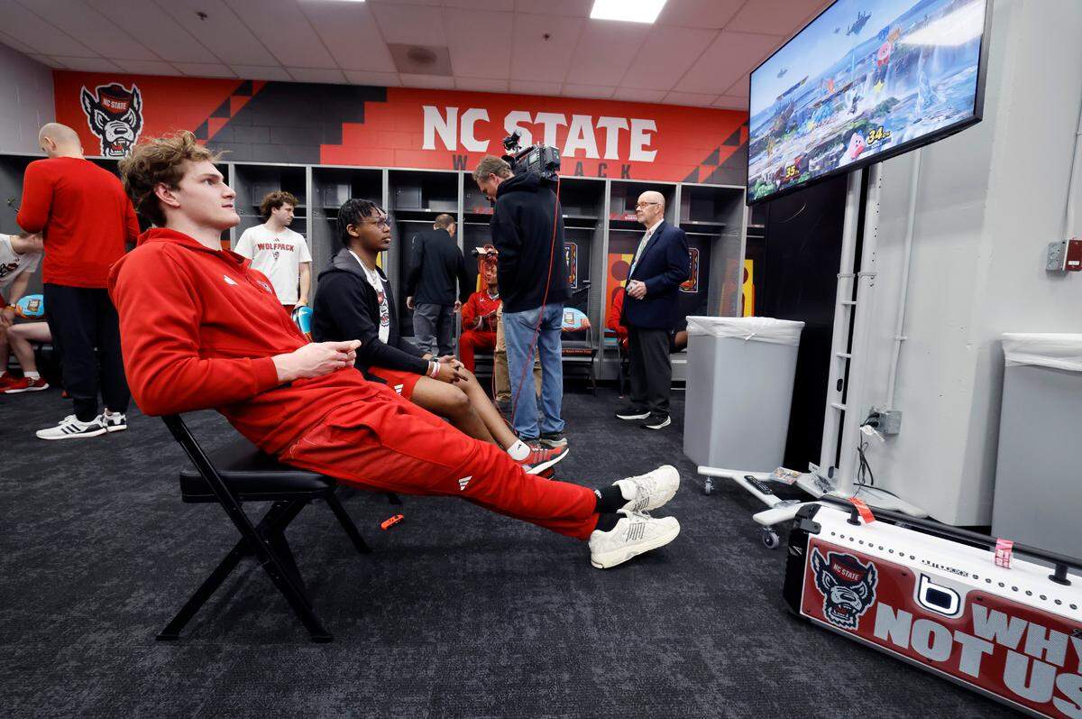 N.C. State’s Ben Middlebrooks plays Super Smash Bros. in the locker room at State Farm Stadium in Glendale, Ariz., Friday, April 5, 2024. The Wolfpack will face Purdue in the NCAA Tournament national semifinals Saturday.