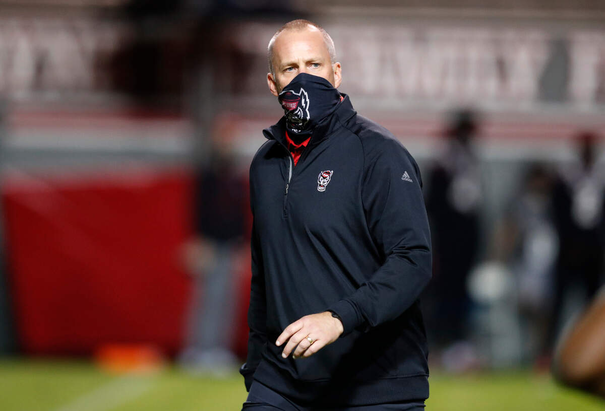 N.C. State head coach Dave Doeren watches his team warmup before N.C. State’s game against Miami at Carter-Finley Stadium in Raleigh, N.C., Friday, Nov. 6, 2020.