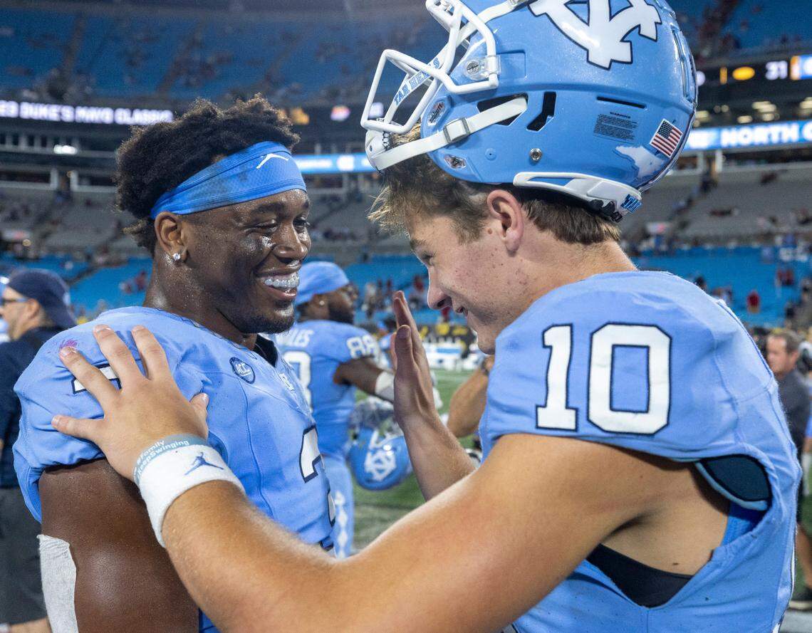 North Carolina quarterback Drake Maye (10) celebrates the Tar Heels’ 31-17 victory over South Carolina with Amari Gainer (3) on Saturday September 2, 2023 at Bank of America Stadium in Charlotte, N.C.