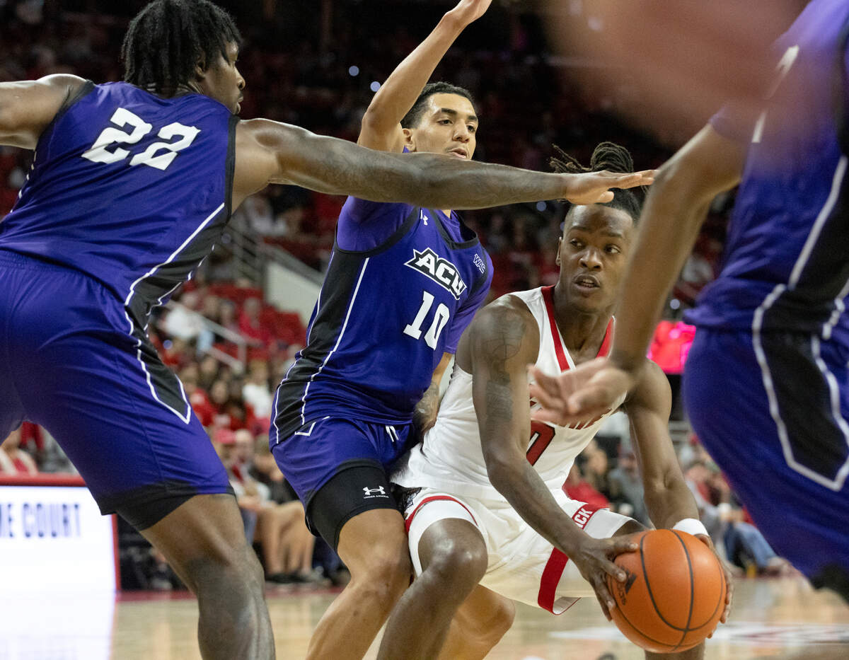 N.C. State’s DJ Horne looks to drive against Abilene Christian’s Aidan Igiehon and Nasir DeGruy during the second half of the Wolfpack’s 84-64 win on Friday, Nov. 10, 2023, at PNC Arena in Raleigh, N.C.