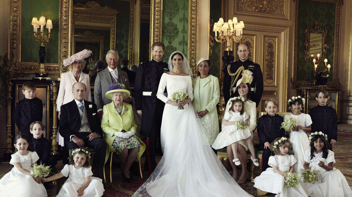In this photo released by Kensington Palace on Monday May 21, 2018, shows an official wedding photo of Britain’s Prince Harry and Meghan Markle, center, in Windsor Castle, Windsor, England, Saturday May 19, 2018. Others in photo from left, back row, Jasper Dyer, Camilla, Duchess of Cornwall, Prince Charles, Doria Ragland, Prince William; center row, Brian Mulroney, Prince Philip, Queen Elizabeth II, Kate, Duchess of Cambridge, Princess Charlotte, Prince George, Rylan Litt, John Mulroney; front row, Ivy Mulroney, Florence van Cutsem, Zalie Warren, Remi Litt.