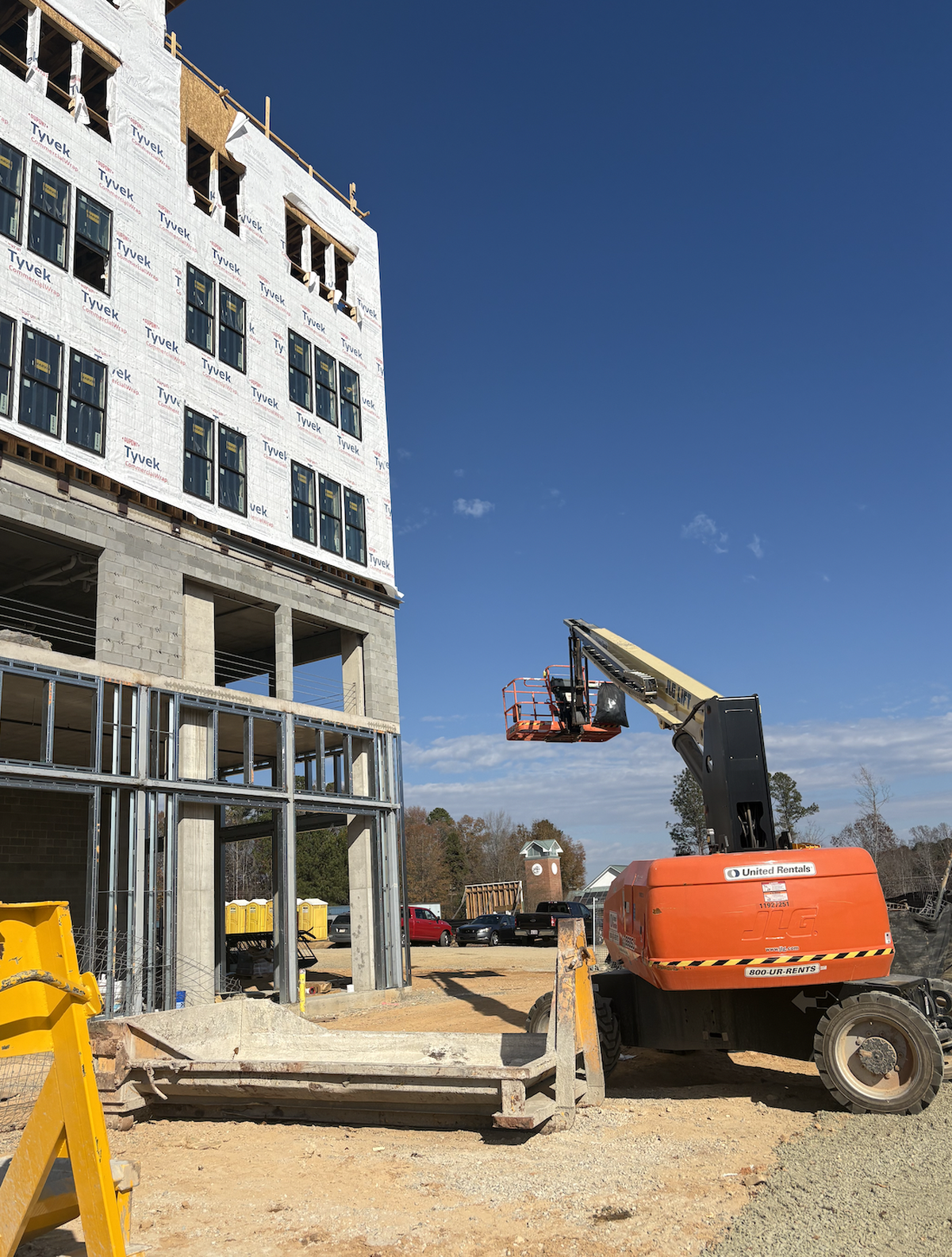 An excavator hangs empty in midair at the South Creek construction site on Wednesday, Nov. 19.