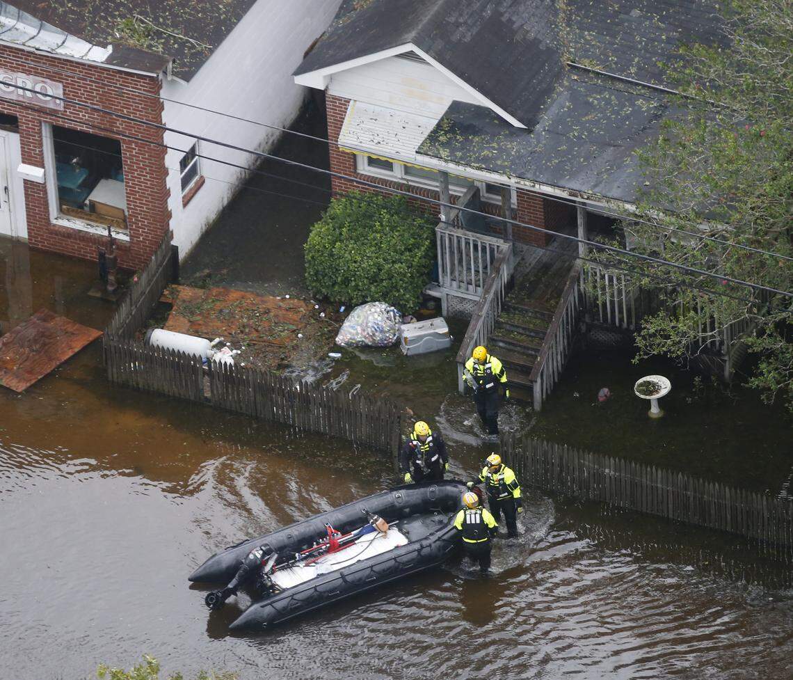 Rescue personnel use a small boat as they go house to house checking for flood victims from Florence, now a tropical storm, in New Bern, NC., Saturday, Sept. 15, 2018.