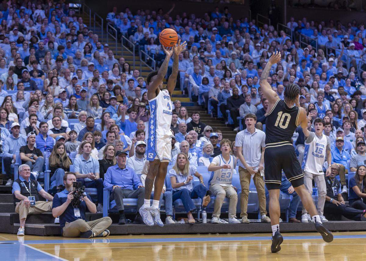 North Carolina guard Jaydon Young (4) launches a three-point shot in the first half against Wake Forest on Saturday, January 10, 2026 at the Smith Center in Chapel Hill, N.C. Young was 3 of 5 from the three point line, scoring 12 points in the Tar Heels’ victory. 