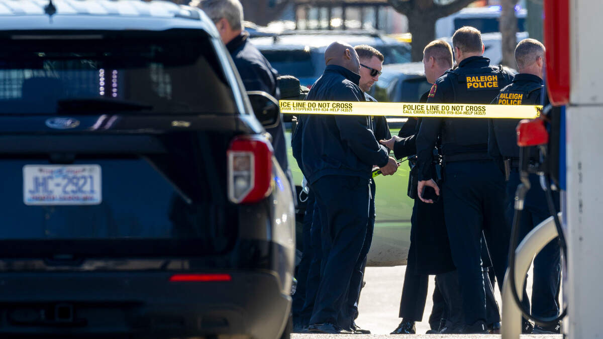 Raleigh Police investigate a possible shooting in N. Hills, adjacent to the Exxon station at the intersection of Lassiter Mill Road and Six Forks Road on Friday, January 17, 2025 in Raleigh, N.C.
