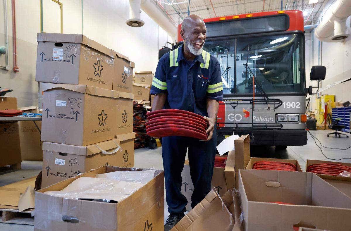 Daniel Moore picks up new vinyl seat backs and bottoms to install on a GoRaleigh bus at its maintenance headquarters off Poole Road in Raleigh, N.C., on Saturday, May 10, 2025.
