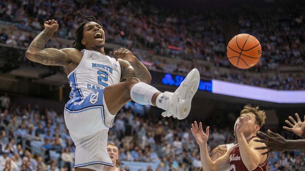 North Carolina’s Caleb Love (2) reacts after a dunk against College of Charleston’s Reyne Smith (2) during the first half on Friday, November 11, 2022 at the Smith Center in Chapel Hill, N.C.