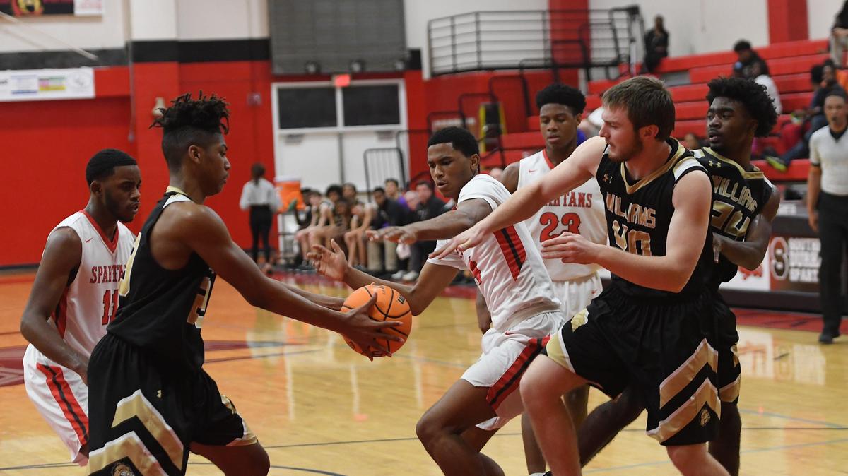 Ricky Council IV, center, of Southern fights over a rebound against Tre Smith, second from left, Jack Smithey (40) and Alijah Richmond (24) of Williams. The Williams Bulldogs visited the Southern Durham Spartans in a high school boys basketball game on February 25, 2020.