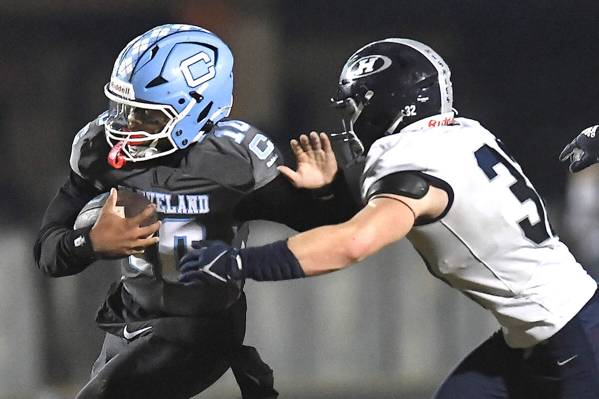 Cleveland quarterback Jackson Byrd (10) runs for yardage against Heritage’s Seth Rucker (32) during the second half. The Cleveland Rams and the Heritage Huskies met in the first round of the NCHSAA 4A playoffs in Clayton, N.C. on November 15, 2024.