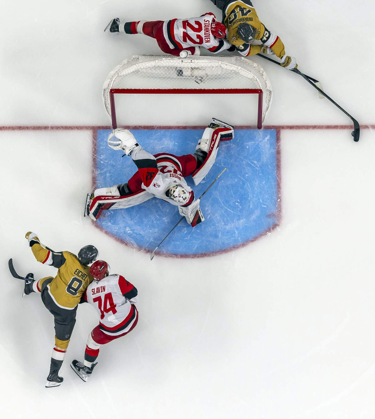 Carolina Hurricanes center Logan Stankoven (22) defends Vegas left wing Ivan Barbashev (49) as he tries score on a wrap around, on goalie Brandon Bussi (32) in the third period of Game 4 of the Stanley Cup Final, on Tuesday, June 9, 2026 in Las Vegas, NV.