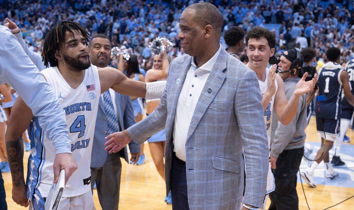 North Carolina coach Hubert Davis embraces R.J. Davis (4) as they leave the court following their 93-84 victory over Duke on Saturday, February, 3, 2024 at the Dean E. Smith Center in Chapel Hill, N.C.