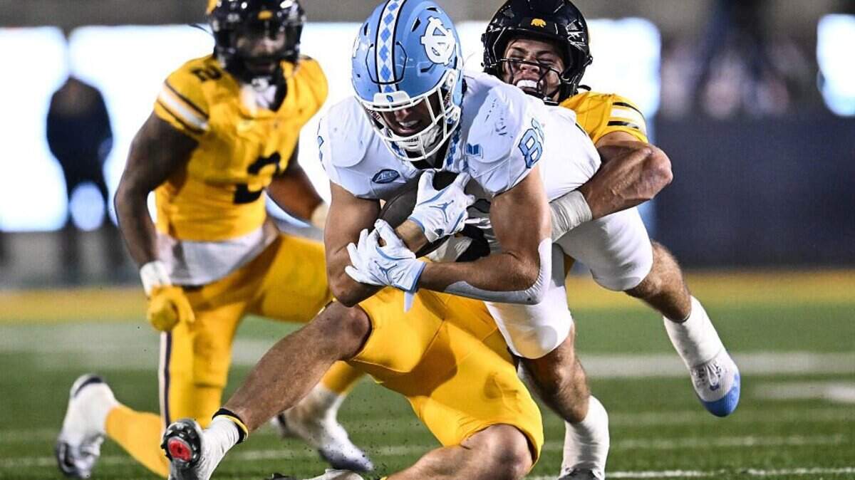 BERKELEY, CALIFORNIA - OCTOBER 17: Connor Co #81 of the North Carolina Tar Heels runs the ball while being tackled by Cade Uluave #0 of the California Golden Bears during the first half at California Memorial Stadium on October 17, 2025 in Berkeley, California. (Photo by Thien-An Truong/Getty Images)