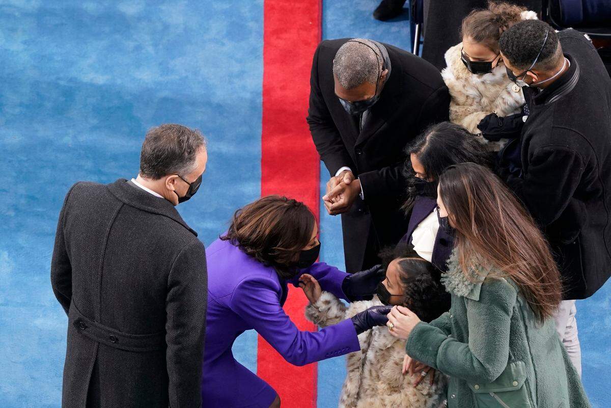 Vice President-elect Kamala Harris and her husband Doug Emhoff, stop to greet a young guest during the 59th Presidential Inauguration at the U.S. Capitol in Washington, Wednesday, Jan. 20, 2021.