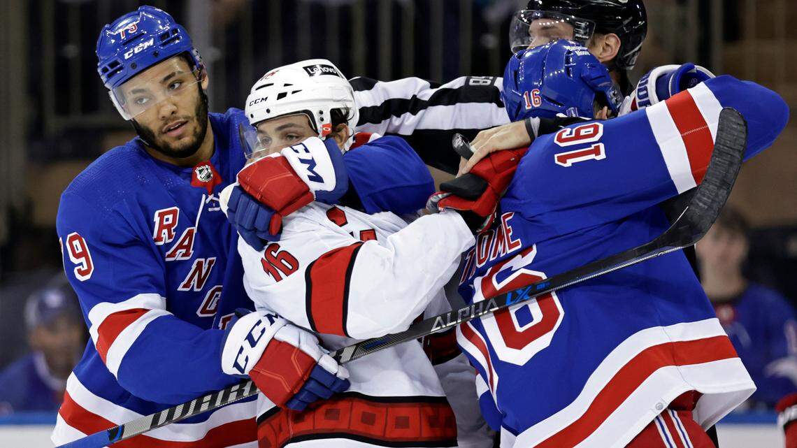 New York Rangers defenseman K’Andre Miller (79) pulls Carolina Hurricanes center Vincent Trocheck (16) off Rangers center Ryan Strome (16) in the first period of Game 3 of an NHL hockey Stanley Cup second-round playoff series, Sunday, May 22, 2022, in New York. (AP Photo/Adam Hunger)