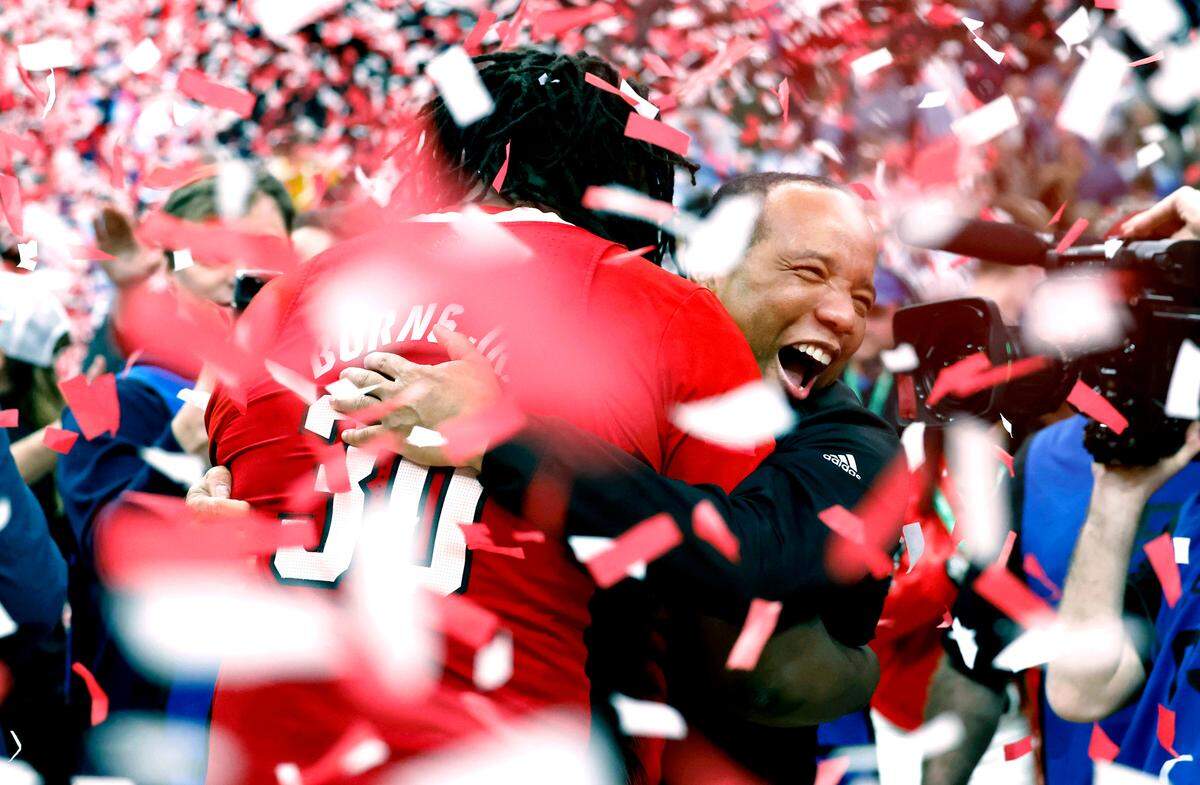N.C. State’s head coach Kevin Keatts hugs DJ Burns Jr. (30) after the Wolfpack’s win over UNC in the 2024 ACC tournament championship game. Photographer Ethan Hyman realized how hard it was to get a good photo of the moment as confetti fell around the arena.