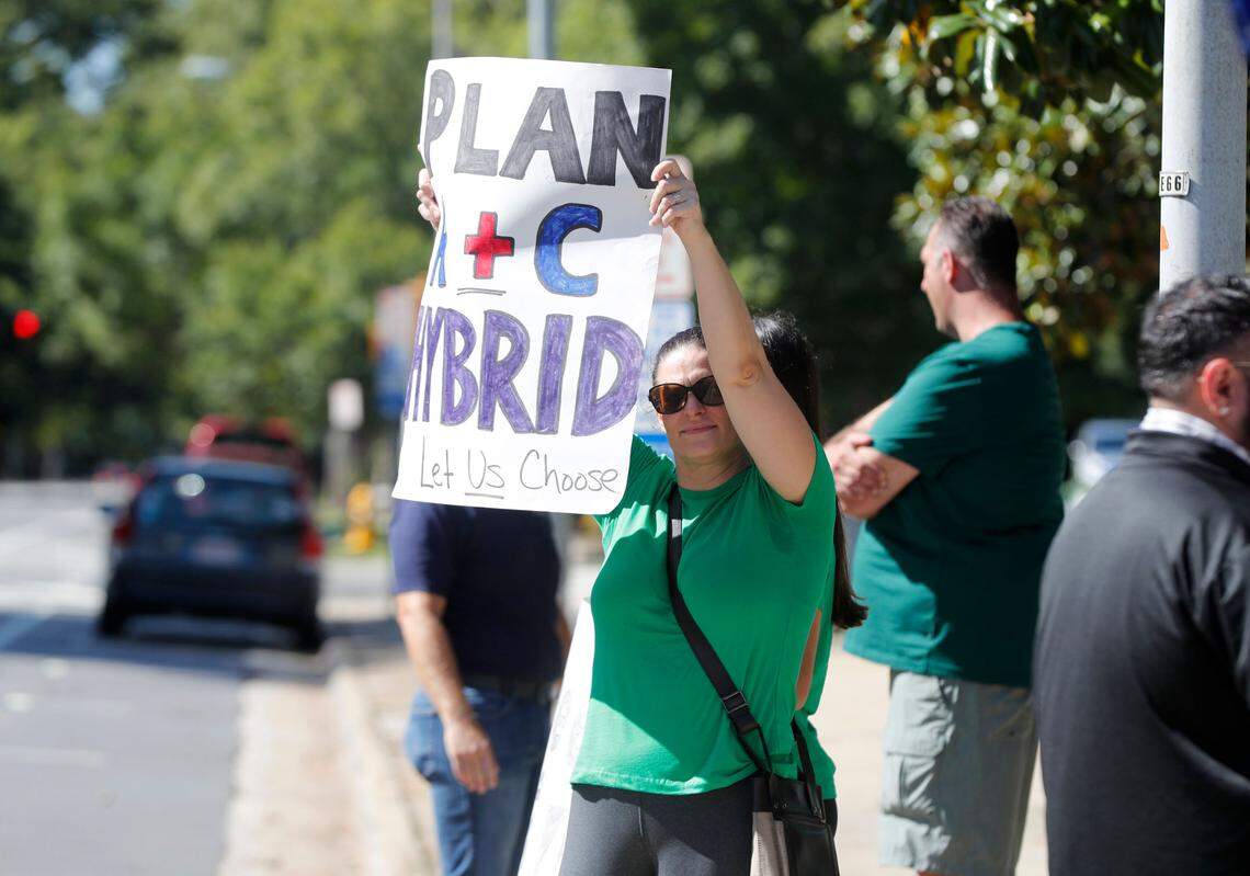 Jennifer Theune of Mooresville, N.C., participates in a rally to return organized by Education is Essential NC outside the Executive Mansion Tuesday, August 4, 2020.