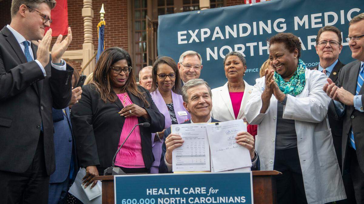Gov. Roy Cooper signs NC Medicaid expansion into law. But it comes with an asterisk.