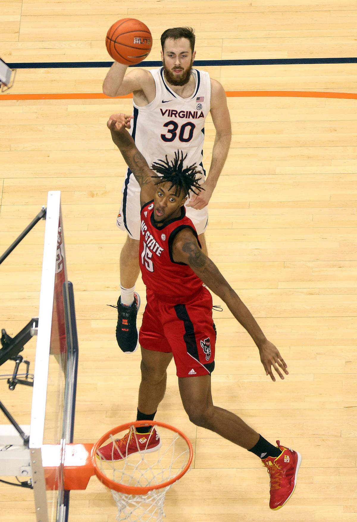Virginia forward Jay Huff (30) shoots a basket over North Carolina State forward Manny Bates (15) during the game Wednesday in Charlottesville.